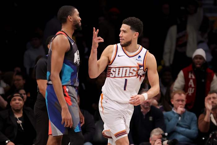 Phoenix Suns guard Devin Booker (1) celebrates his three point shot against Brooklyn Nets forward Mikal Bridges (1)
